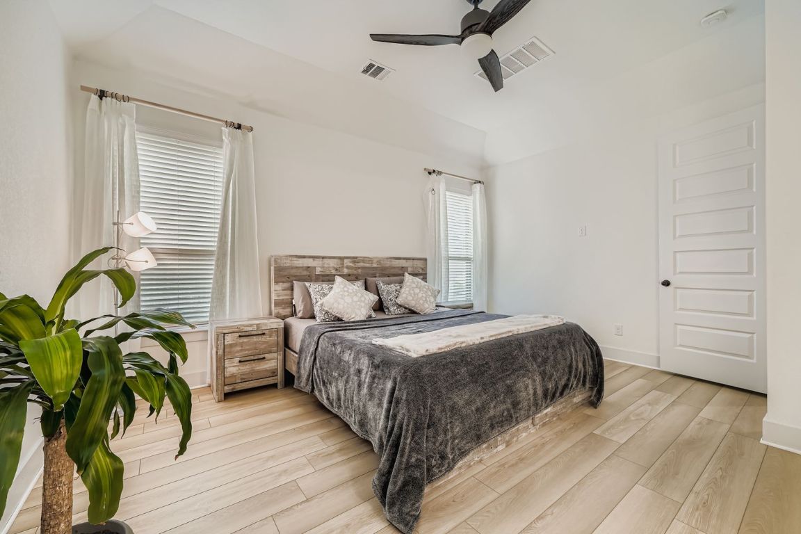 324 Clear Frk Loop Liberty Hill, TX 78642 - Photo 15 of 28 a bedroom with a bed potted plant with the dresser