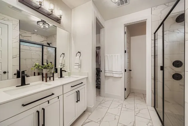 a bathroom with a double vanity sink a and a mirror