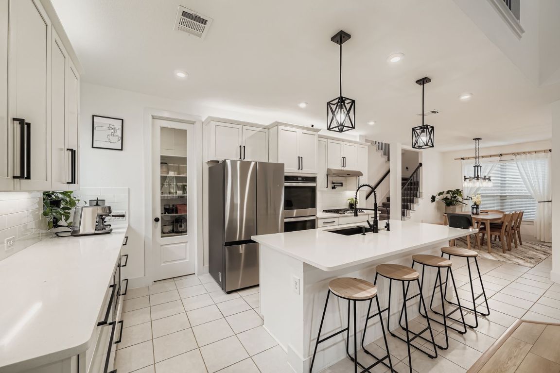 324 Clear Frk Loop Liberty Hill, TX 78642 - Photo 10 of 28 a view of a kitchen with kitchen island dining table and stainless steel appliances
