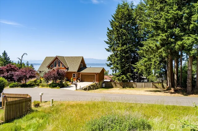 a swimming pool with outdoor seating and yard