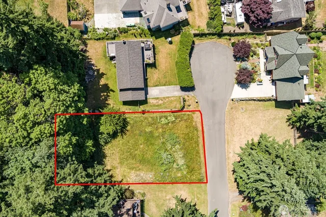 an aerial view of a house with a yard and garden