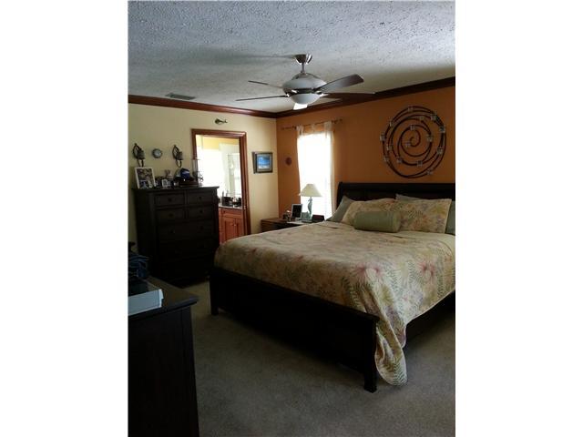 12757 Sandy Run Road Jupiter, FL 33478 - Photo 11 of 25 a bedroom with a bed and a window