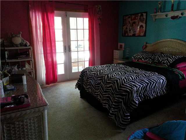 12757 Sandy Run Road Jupiter, FL 33478 - Photo 16 of 25 a bed sitting in a bedroom next to a window