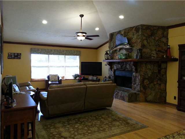 12757 Sandy Run Road Jupiter, FL 33478 - Photo 7 of 25 a living room with furniture a flat screen tv and a fireplace