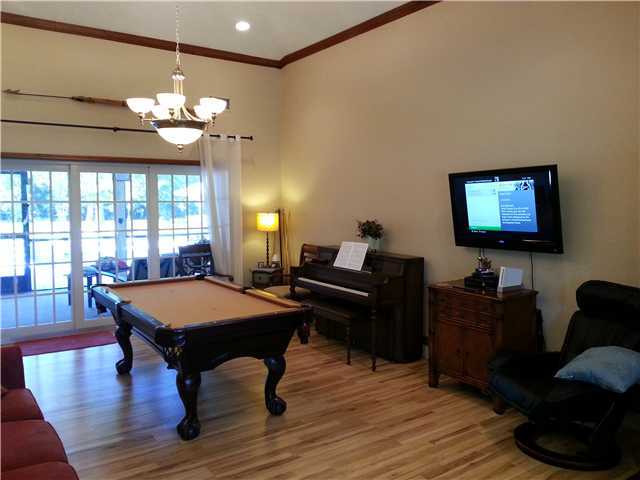 12757 Sandy Run Road Jupiter, FL 33478 - Photo 9 of 25 a room with furniture pool table flat screen tv and windows