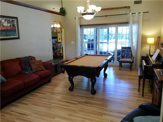 12757 Sandy Run Road Jupiter, FL 33478 - Photo 10 of 25 a living room with furniture a table and wooden floor