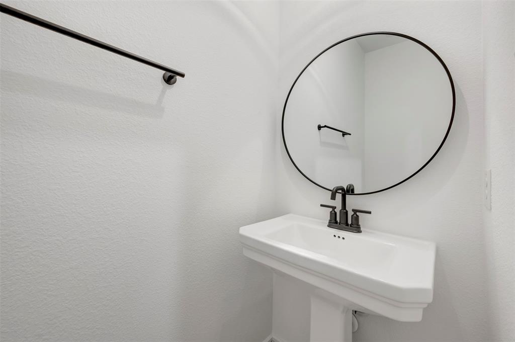 1014 Butterfly Lane Justin, TX 76247 - Photo 26 of 40 a bathroom with a sink and mirror