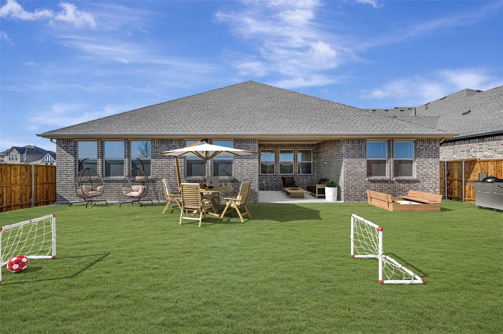 1014 Butterfly Lane Justin, TX 76247 - Photo 31 of 40 a view of a house with backyard porch and sitting area