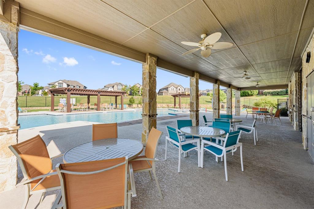 1014 Butterfly Lane Justin, TX 76247 - Photo 33 of 40 a dining room with furniture a chandelier and a floor to ceiling window