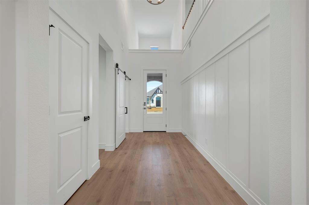 1014 Butterfly Lane Justin, TX 76247 - Photo 4 of 40 a view of a hallway with wooden floor
