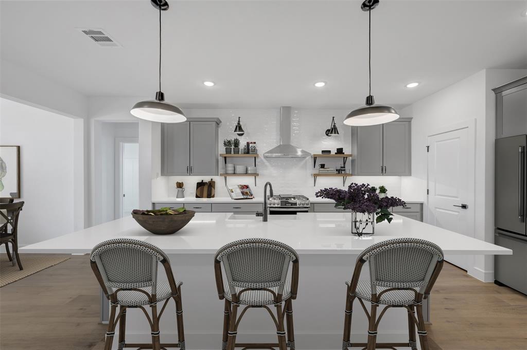 1014 Butterfly Lane Justin, TX 76247 - Photo 8 of 40 a kitchen with sink and chairs
