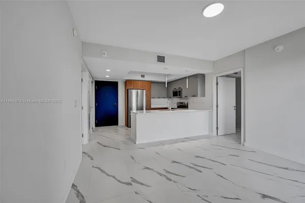 a view of kitchen with refrigerator and window