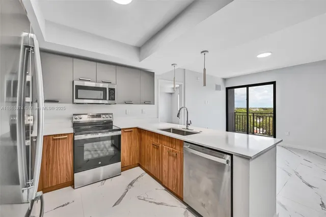a kitchen with stainless steel appliances granite countertop a sink stove and refrigerator