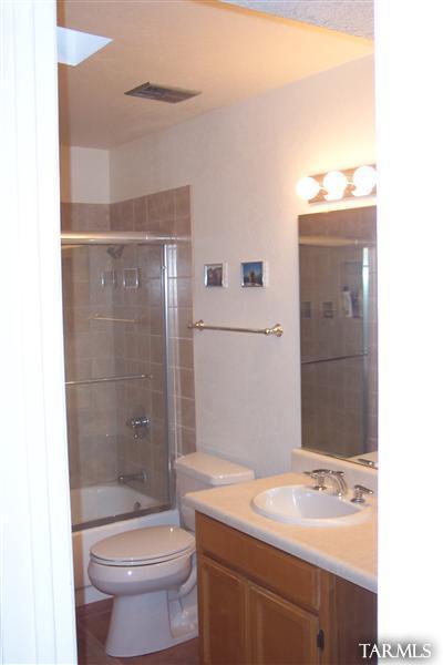 4318 East Allison Road Tucson, AZ 85712 - Photo 8 of 10 a bathroom with a sink toilet and shower