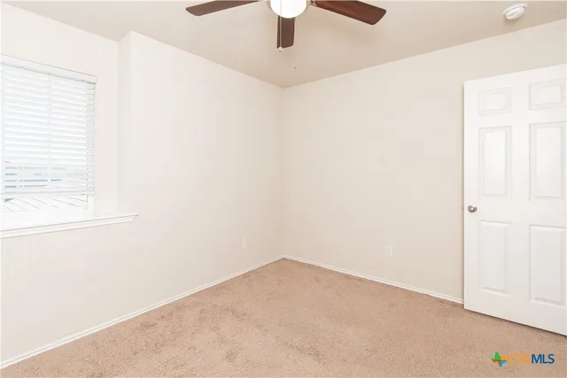 an empty room with fan