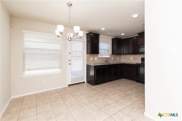 a spacious bathroom with a granite countertop sink a mirror and a vanity