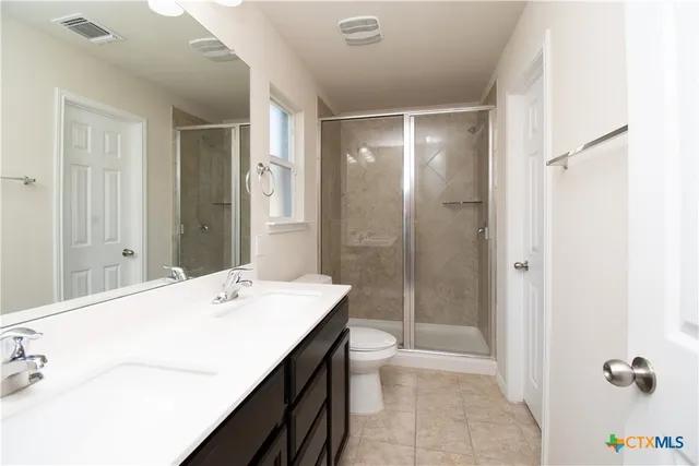 a bathroom with a tub sink mirror and shower