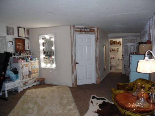 1355 South Mahan Street Ridgecrest, CA 93555 - Photo 15 of 35 a living room with furniture and a mirror