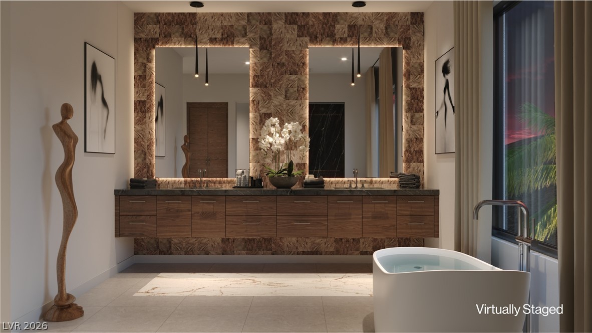 507 Overlook Rim Drive Henderson, NV 89012 - Photo 13 of 22 Indulge in a tranquil bathing experience with a freestanding tub and a dual vanity with ample storage.