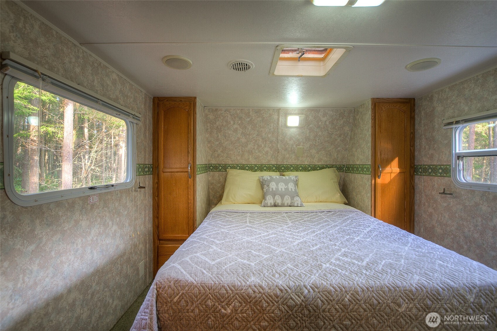 67 Frances Lane Lopez Island, WA 98261 - Photo 14 of 32 a large bed sitting in a room next to a window