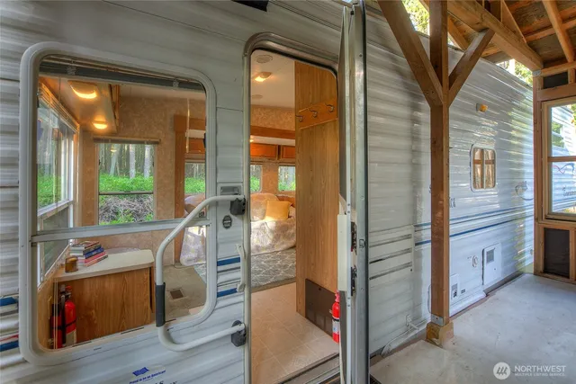 a kitchen with stainless steel appliances granite countertop a refrigerator a sink dishwasher and a fireplace with wooden floor