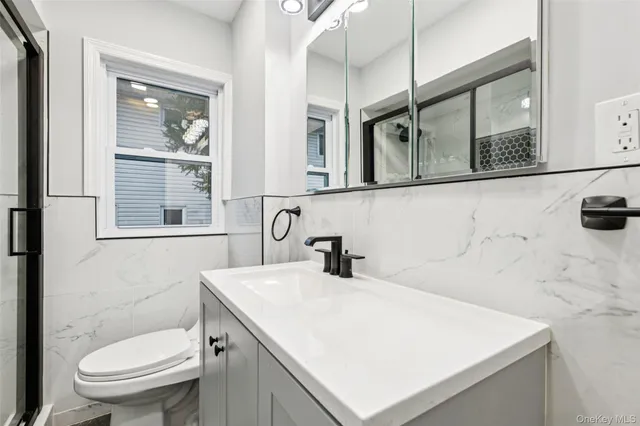 a bathroom with a sink a toilet and mirror