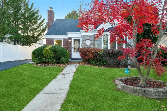 a front view of a house with a garden