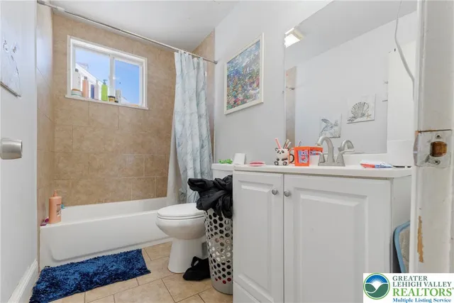 a bedroom with two beds and a window