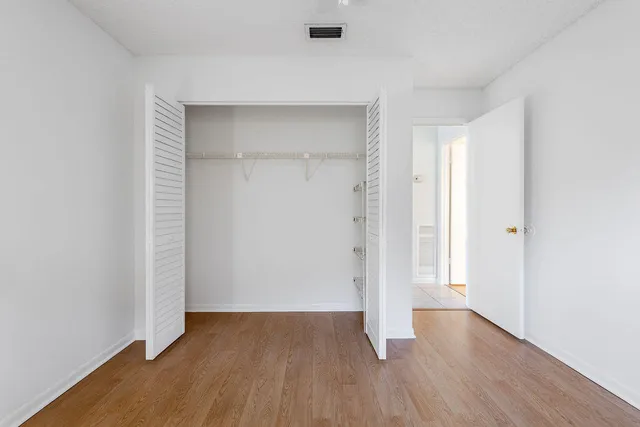 an empty room with wooden floor