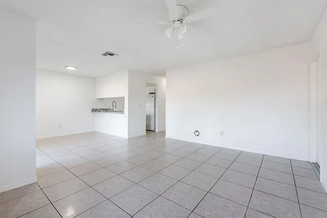 a view of an empty room and a window