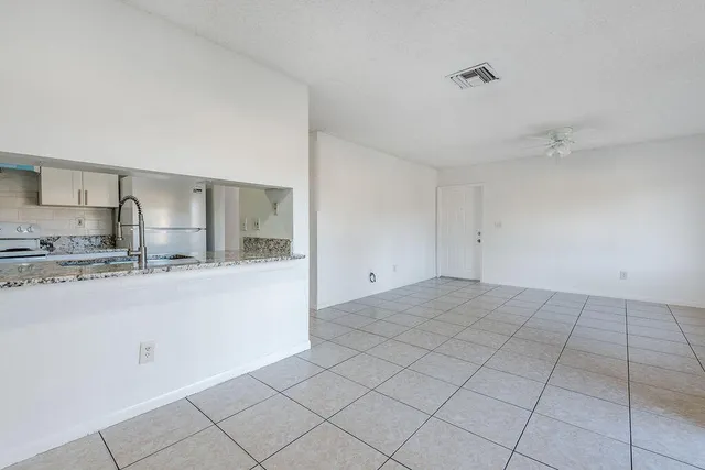 a kitchen with granite countertop a sink and cabinets