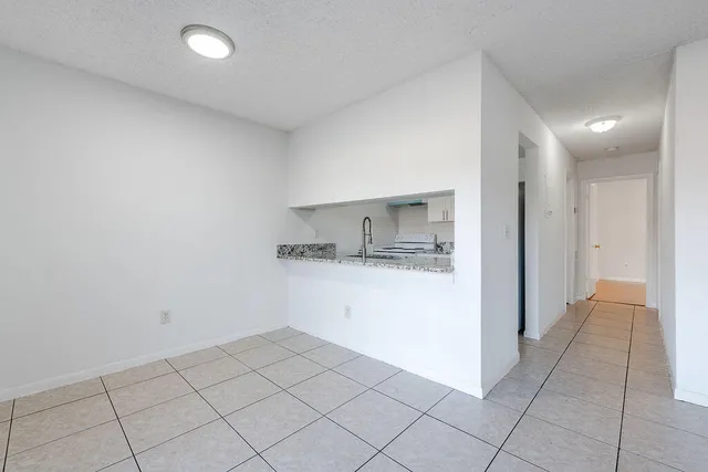 a view of a kitchen with a sink and a refrigerator