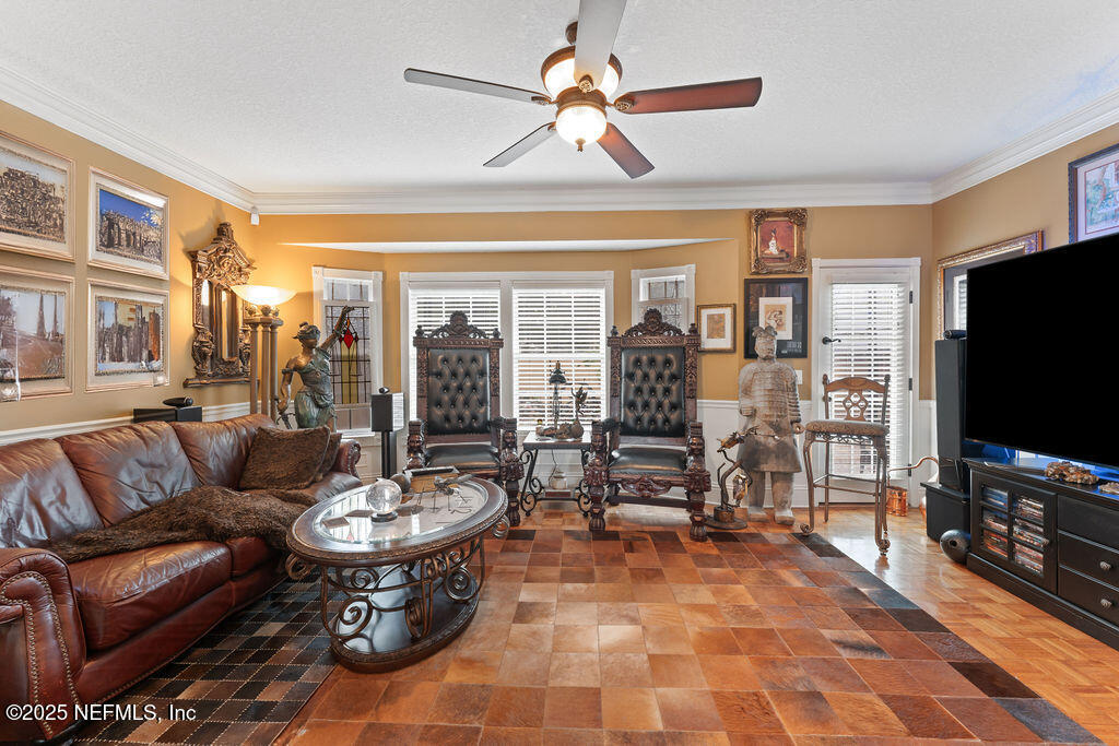 43 Valencia Street St. Augustine, FL 32084 - Photo 11 of 48 a living room with furniture a flat screen tv and a dining table