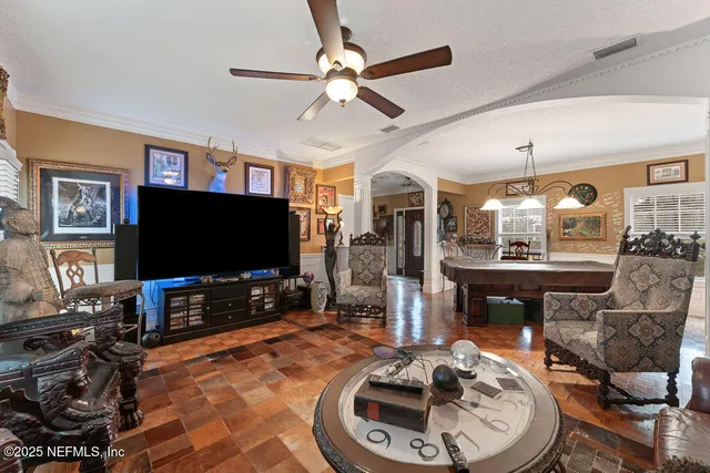 a living room with fireplace furniture and a chandelier