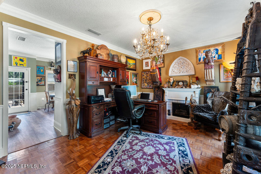 43 Valencia Street St. Augustine, FL 32084 - Photo 16 of 48 a living room with fireplace furniture and a chandelier