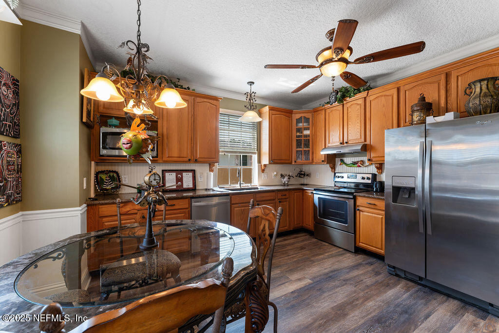 43 Valencia Street St. Augustine, FL 32084 - Photo 17 of 48 a kitchen with granite countertop a sink appliances and wooden floor
