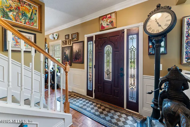 a view of a dining room with furniture and a chandelier