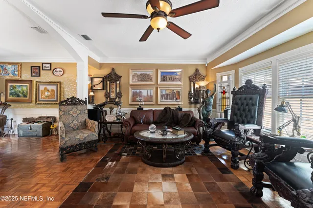 a living room with furniture a flat screen tv and a dining table