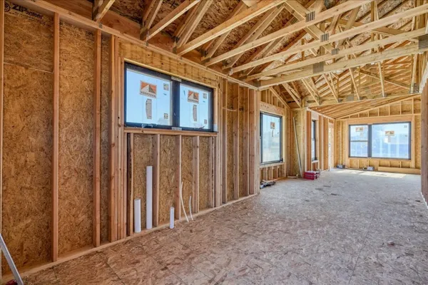 a view of a hallway with wooden walls