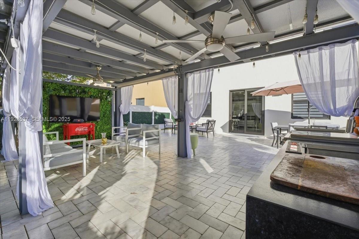 3522 West 86th Terrace Hialeah, FL 33018 - Photo 12 of 35 a view of a patio with a table chairs and a barbeque