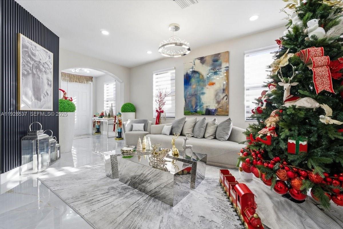 3522 West 86th Terrace Hialeah, FL 33018 - Photo 14 of 35 a living room with furniture a flowers and a fireplace