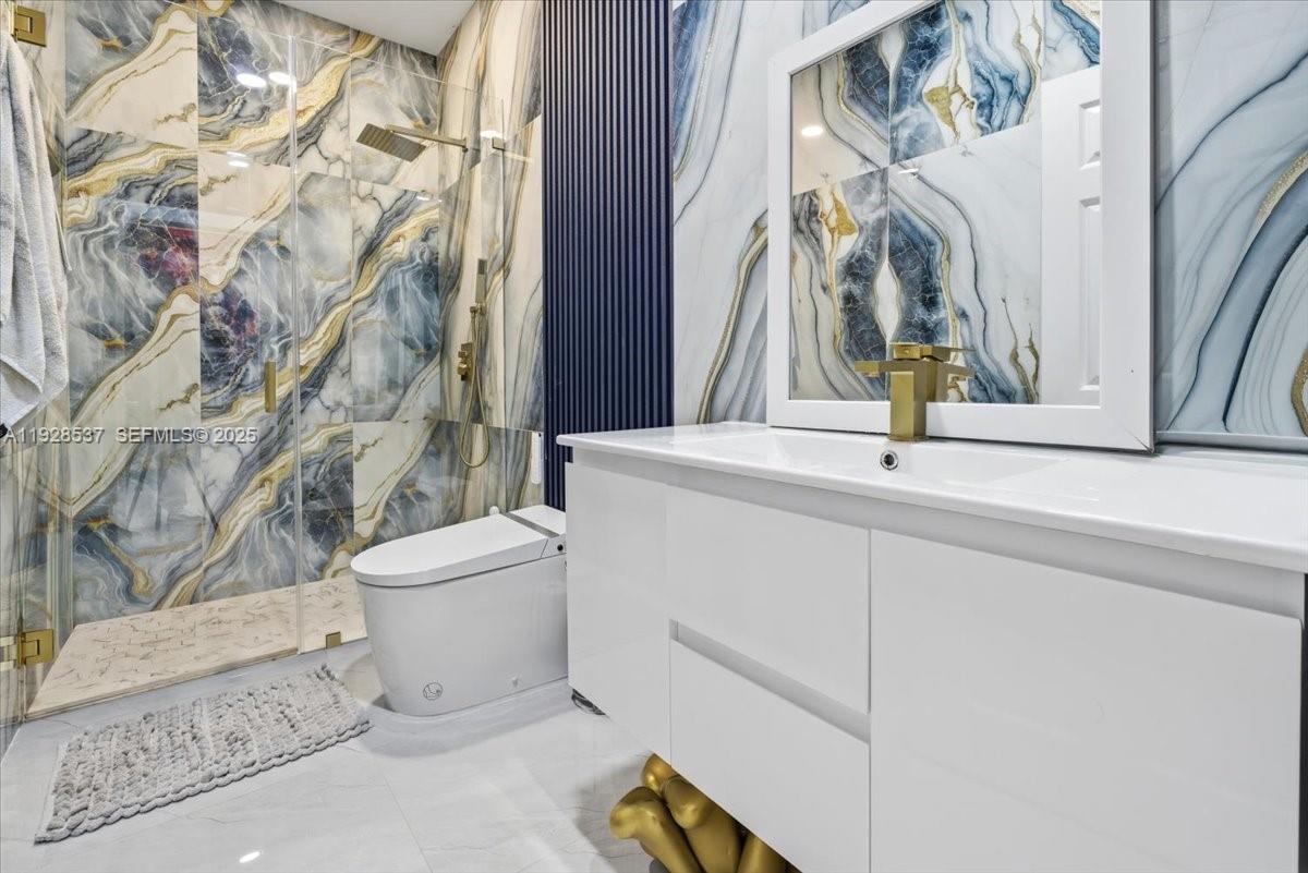 3522 West 86th Terrace Hialeah, FL 33018 - Photo 22 of 35 a bathroom with a sink and a toilet