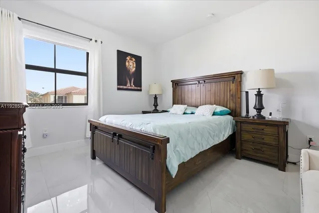 a bedroom with a bed chair and a window