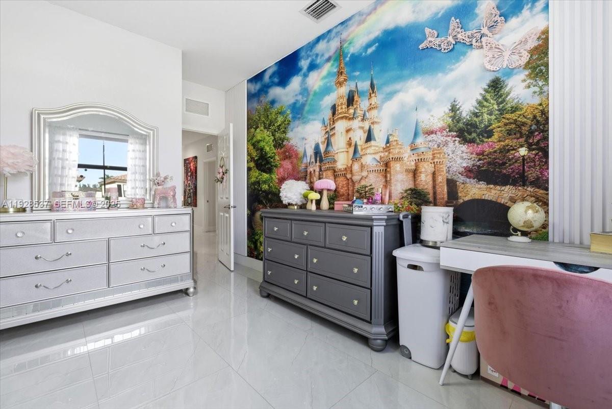 3522 West 86th Terrace Hialeah, FL 33018 - Photo 26 of 35 a room with a dresser and a mirror