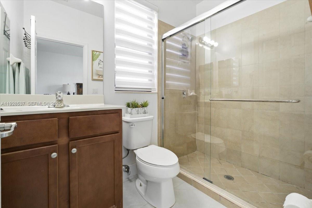 3522 West 86th Terrace Hialeah, FL 33018 - Photo 28 of 35 a bathroom with a sink a toilet and shower