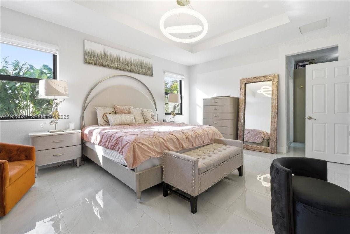 3522 West 86th Terrace Hialeah, FL 33018 - Photo 33 of 35 a bedroom with a bed couch and window