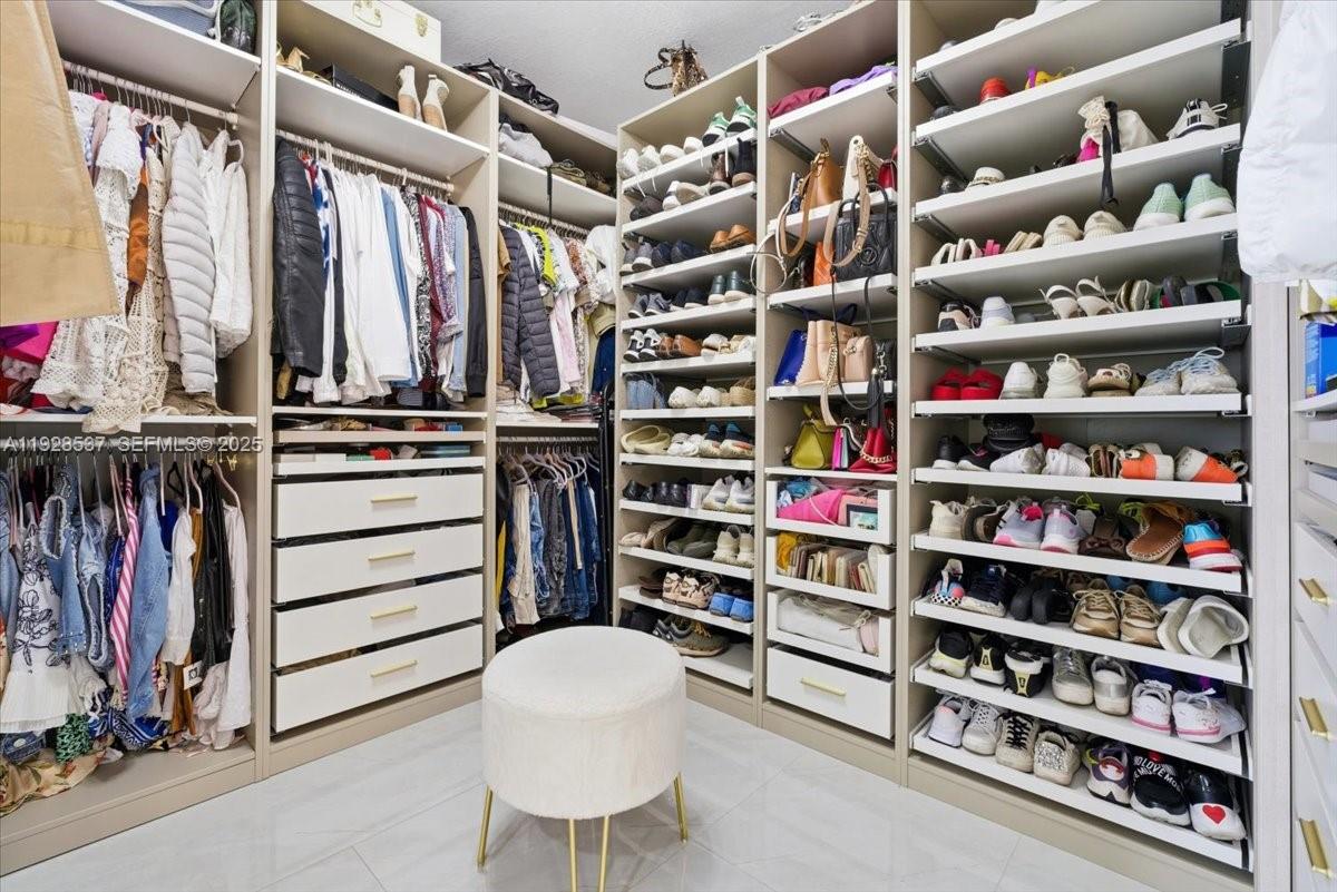 3522 West 86th Terrace Hialeah, FL 33018 - Photo 34 of 35 a view of walk in closet with clothes and shoes