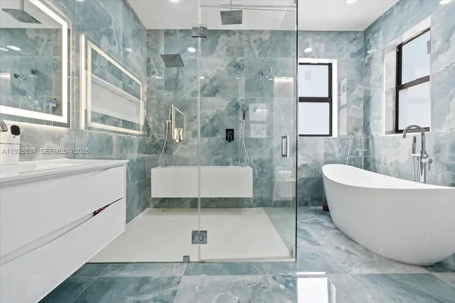 a white bath tub sitting next to a white toilet