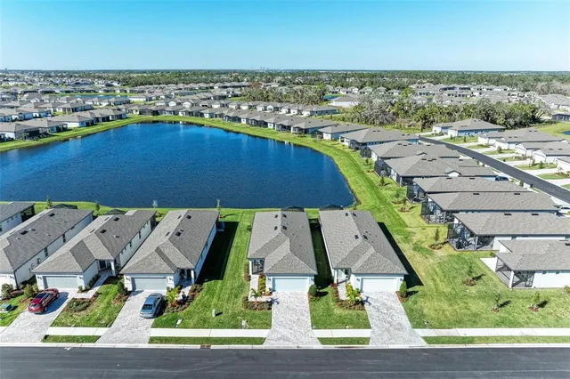 an aerial view of residential houses with outdoor space