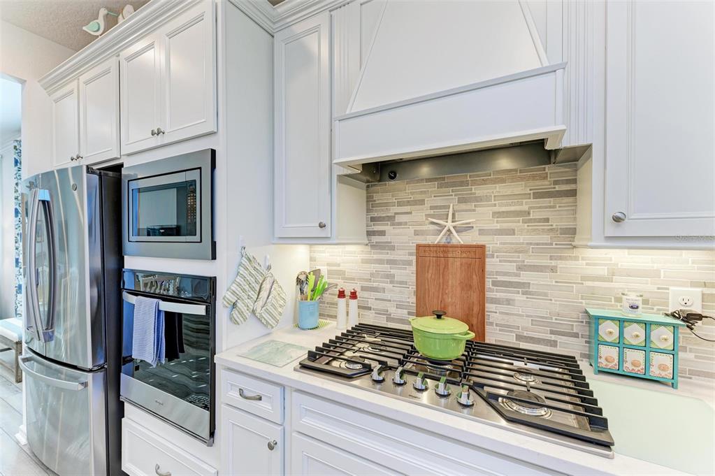 9272 Ballaster Pointe Loop Parrish, FL 34221 - Photo 20 of 79 a kitchen with stainless steel appliances granite countertop a stove and a refrigerator